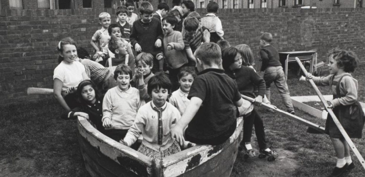 Black and white photograph of a group of children in a boat